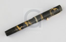 A Dunhill Namiki black lacquered fountain pen, decorated with cranes flying amongst clouds,