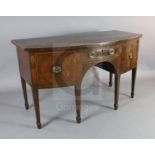 A George III mahogany bowfront sideboard, with central drawer flanked by a cupboard and deep drawer,