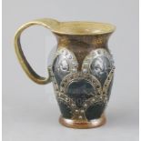 A Martin Brothers mug, late 19th century, with arched embossed decoration to the baluster shaped