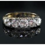 A Victorian style gold and graduated five stone diamond half hoop ring, with carved setting, the