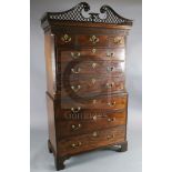 A George III mahogany chest on chest, with fretted swan neck pediment, blind fret carved frieze,