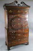 A George III mahogany chest on chest, with fretted swan neck pediment, blind fret carved frieze,