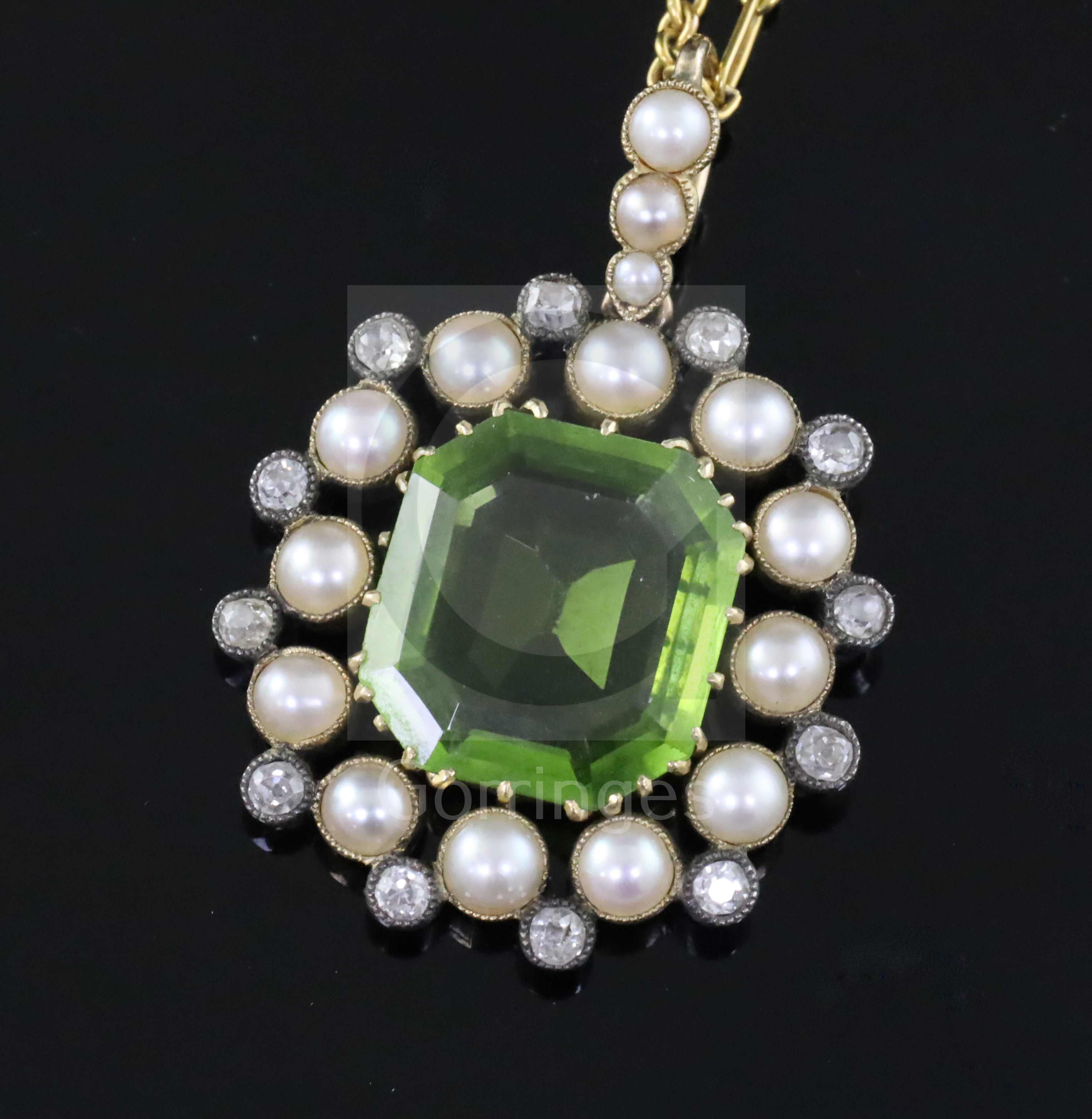 A late Victorian gold and silver, peridot, split pearl and diamond set pendant, in fitted gilt