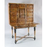 A Louis XIV inlaid walnut cabinet on stand, the upper section with twelve short drawers