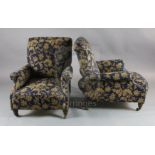 A pair of Victorian club armchairs, with blue floral scroll upholstery, on turned mahogany legs