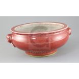 A Chinese sang de boeuf glazed censer, the exterior modelled with a pair of mask ring handles, the