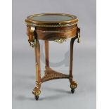 An early 20th century French mahogany and marquetry bijouterie table, with glazed circular drum