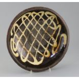 An English slipware circular baking dish, 18th / 19th century, decorated with a lattice design in