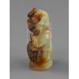 A Chinese pale celadon and russet jade finial, Song dynasty or later, carved in the form a lion with