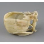 A Chinese jade 'peach' cup, probably 17th / 18th century, the creamy coloured stone with some