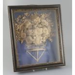 A George III cut-card relief picture, modelled as a basket of flowers, mounted within an ebonised