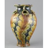 Frank A Butler for Doulton, a hand-built leaf design vase, c.1895, with wrythen modelled body and