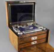 A Victorian burr walnut two drawer travelling toilet box containing ten silver mounted jars or