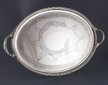 A Victorian silver oval two handled tea tray by Horace Woodward & Co, with engraved decoration and