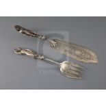 A pair of Victorian silver fish servers, with cast figural handles modelled as a fisherman and his