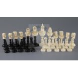 A 19th century, possibly French Colonial, black stained and natural ivory chess set, Moors versus