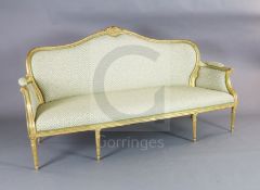 A Louis XVI style giltwood settee, with scroll, harebell and paterae carved frame, on turned tapered