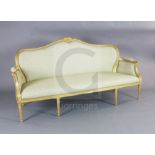 A Louis XVI style giltwood settee, with scroll, harebell and paterae carved frame, on turned tapered