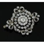 A Victorian, gold, silver and old mine cut diamond set pendant brooch, of pierced circular form,