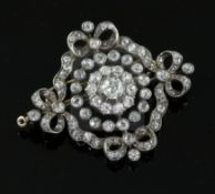 A Victorian, gold, silver and old mine cut diamond set pendant brooch, of pierced circular form,