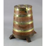An early 19th century brass bound staved oak salt beef barrel, on raised feet, by repute the wood