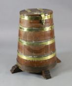 An early 19th century brass bound staved oak salt beef barrel, on raised feet, by repute the wood