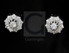 A pair of white gold and diamond cluster ear studs, each set with ten round cut stones, 10mm,.