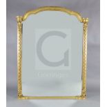 A Victorian giltwood overmantel mirror, with arched top and blind fret carved pilasters, W.4ft