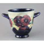 A William Moorcroft 'Pansy' jardiniere, c.1915, applied with a pair of looped handles, with a pale