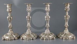 An ornate set of four Victorian rococco style silver candlesticks, Creswick & Co (Thomas James &