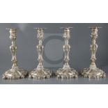 An ornate set of four Victorian rococco style silver candlesticks, Creswick & Co (Thomas James &