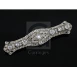 A 1920's pierced platinum? and millegrain set diamond bar brooch, set with round cut stones, the