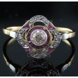 A 1920's gold and platinum, ruby and diamond set cluster ring, the pierced setting with central
