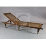 An early 19th century oak folding campaign day bed, the underside bearing a paper label - ''From