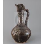 A Turkish Cannakale pottery ewer, 19th century, applied with medallions and scroll decoration and