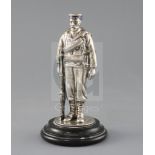 A late Victorian novelty silver and enamel inkwell, modelled as a sailor from HMS Duke of