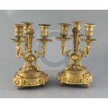 A pair of Louis XVI style ormolu candelabra, with central torch stems, triple foliate scrolled