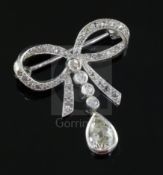 An early 20th century platinum? and diamond drop ribbon bow brooch, millegrain set with round and