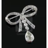 An early 20th century platinum? and diamond drop ribbon bow brooch, millegrain set with round and