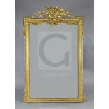 A late 19th French giltwood and gesso wall mirror, with musical pediment and floral swagged