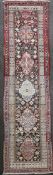 A Persian ivory ground runner, with filed of hooked geometric motifs and multi row border, 13ft