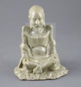 A Chinese celadon glazed figure of Laozi, 18th / 19th century, model cross-legged and seated on