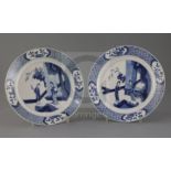 A pair of Chinese blue and white 'ladies' plates, Kangxi period, each painted with two ladies in a