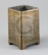 A Chinese bronze and silver inlaid square brush pot, decorated with lion dog and brocade ball