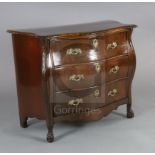 A late 19th century French flame mahogany bombe commode, with floral carved frieze and angles