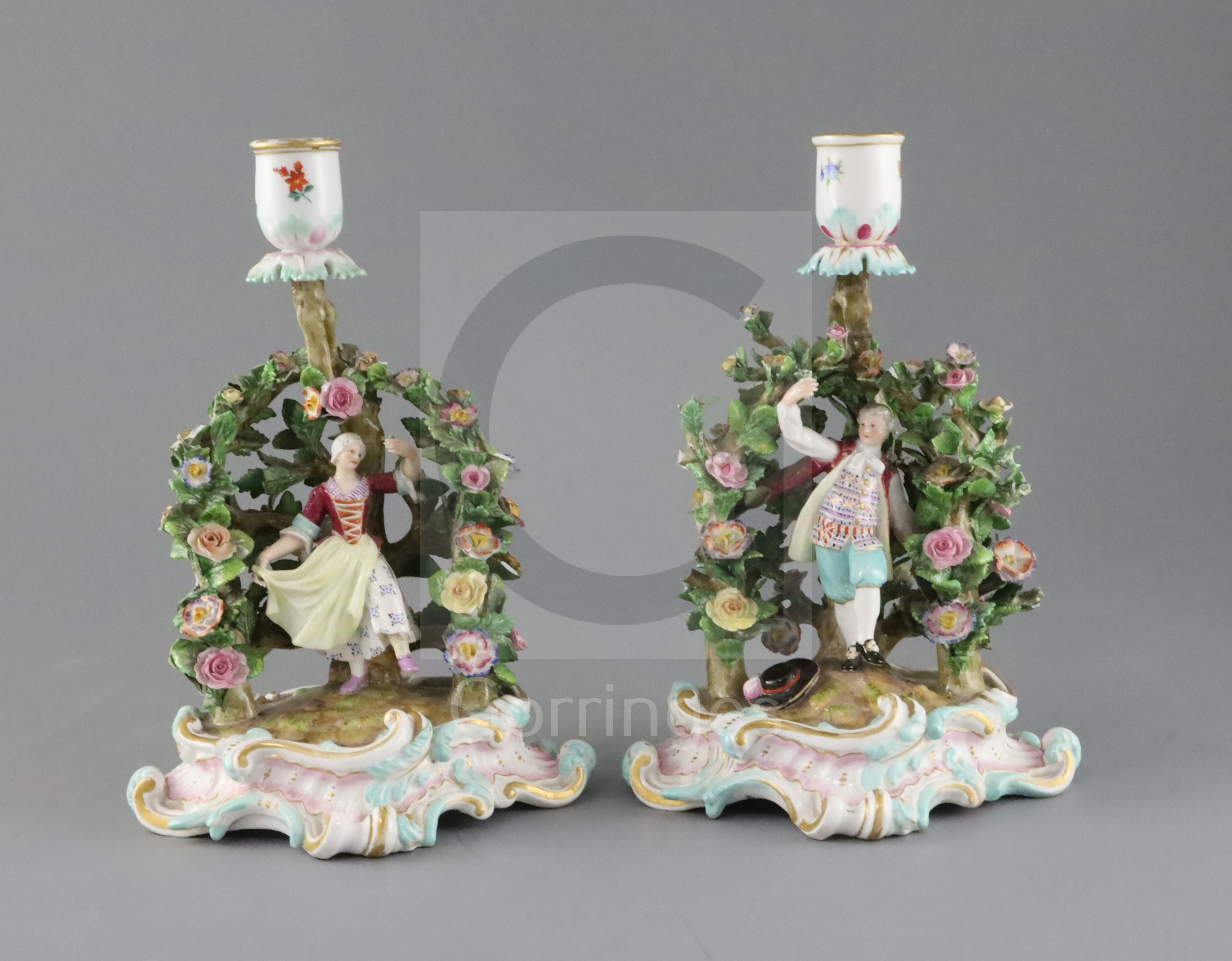 A pair of Meissen figural candlesticks, late 19th century, each modelled with a figure of either a