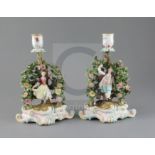 A pair of Meissen figural candlesticks, late 19th century, each modelled with a figure of either a