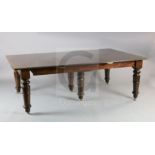 An early Victorian mahogany extending dining table, with rounded rectangular top, six spare