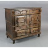 A late 17th century oak chest, of four long drawers with geometric moulded decoration, on stile