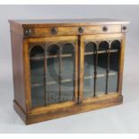 A William IV rosewood bookcase, with frieze drawer over two astragal glazed doors enclosing shelves,